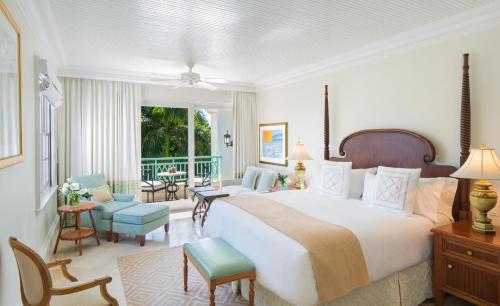 a bedroom with a large bed and a living room at The Palms Turks and Caicos in Grace Bay