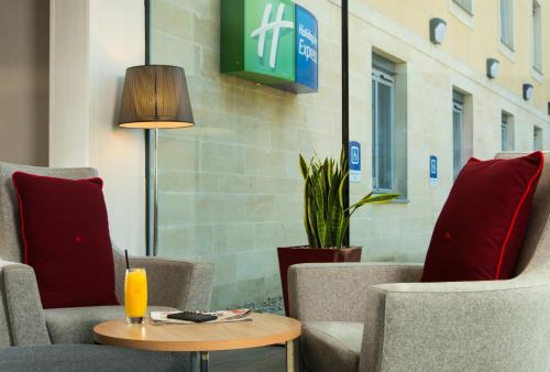 a room with chairs and a table with a lamp at Holiday Inn Express Bath, an IHG Hotel in Bath