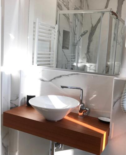a bathroom with a white sink and a mirror at Civico21 in Padova