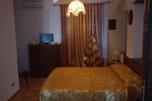 a bedroom with a bed and a television in it at Bed & Breakfast Laino in Maratea