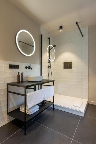 a bathroom with a sink and a shower at THE ADAMS - Self Check In Hotel in Baden-Baden