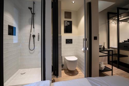 a bathroom with a shower and a toilet at THE ADAMS - Self Check In Hotel in Baden-Baden