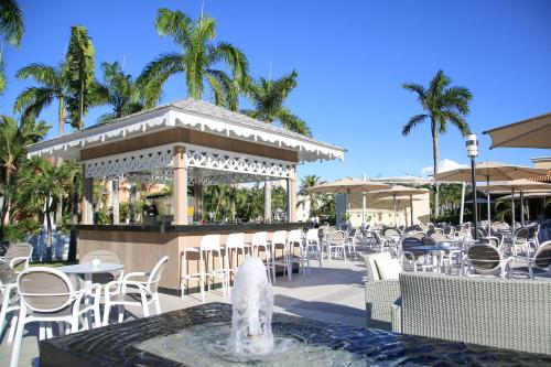 a restaurant with tables and chairs and a fountain at Bahia Principe Grand Punta Cana - All Inclusive in Punta Cana