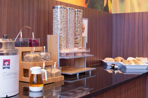 a bakery with bread and pastries on a counter at Fairfield Inn & Suites by Marriott New York Queens/Fresh Meadows in Queens
