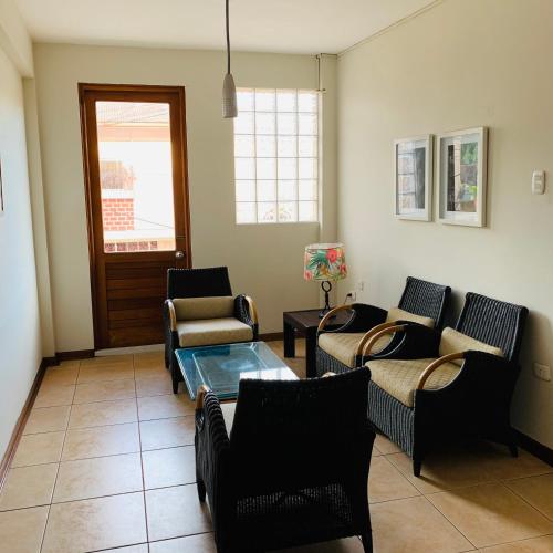 a living room with couches and a table at Hotel Acosta in Iquitos