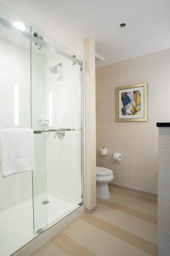 a glass shower in a bathroom with a toilet at Fairfield Inn & Suites by Marriott New York Queens/Fresh Meadows in Queens