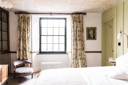 a bedroom with a bed and a window at The Bull Inn in Totnes