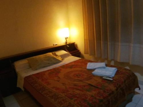 a bedroom with a bed with two towels on it at casa lucy in Puerto Iguazú