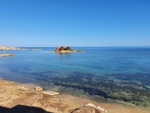 a small island in the middle of the ocean at Casa I Sogni In Terrazzo in Marzamemi