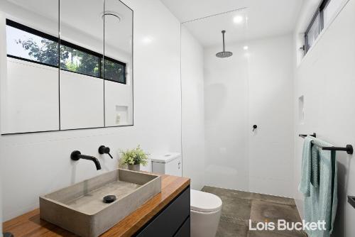 a bathroom with a sink and a toilet at Crows Nest in Lennox Head