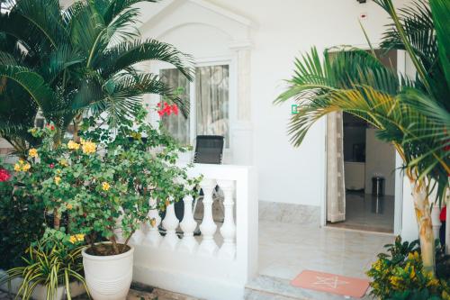 a hallway with plants and a white fence at Godiva Villa Phu Quoc in Phu Quoc