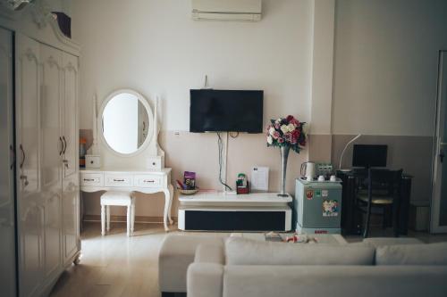 a living room with a couch and a mirror at Godiva Villa Phu Quoc in Phu Quoc