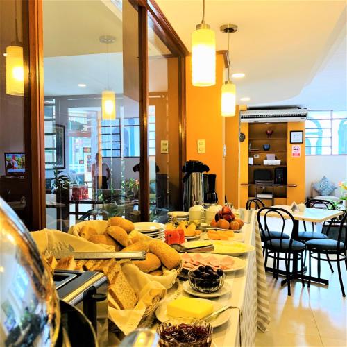 a table with plates of food on top of it at Hotel Acosta in Iquitos