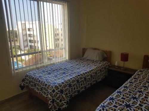 Una cama o camas en una habitación de Depa Playa Halcon