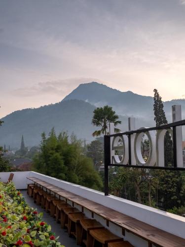 a row of benches with a mountain in the background at Three Eight Front One Boutique Batu Malang in Batu