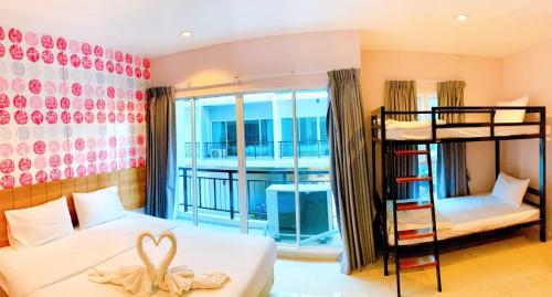 a bedroom with two bunk beds and a balcony at The Bedroom Ladprao 101 Bangkok - SHA in Bangkok