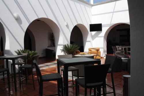 a restaurant with tables and chairs in a room at Hotel Villa Mexicana Golf & Equestrian Resort in Villa del Pueblito