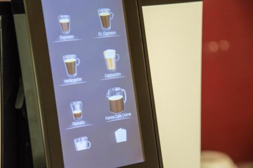 a vending machine filled with cups of beer at Hotel Römerhof in Tulln