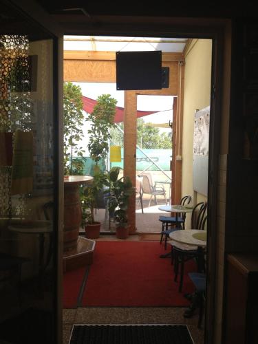 an open door to a patio with a table and chairs at Pension Tennisweber in Schwechat