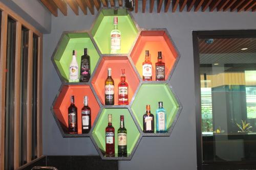 a display of bottles of wine on a wall at H-District Boutique Poshotel in Bangkok