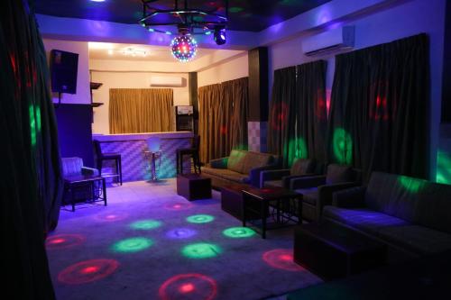 a living room with a couch and a fireplace at HOTEL MALLIKA COMPANY, SL in Freetown