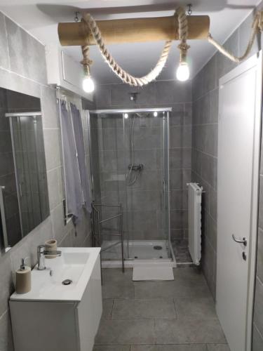 a bathroom with a shower and a toilet and a sink at Sweet House Self Check-in 24h in Cavallasca