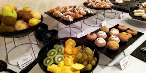 a buffet of different types of pastries on display at Hotel La Martinica in Ficarazzi