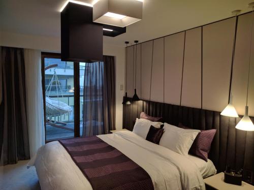 a bedroom with a large bed and a balcony at Juniper Apartment in Braşov