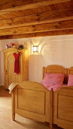 a bedroom with a wooden bed and a wooden ceiling at B B Guesthouse TIHANY in Tihany