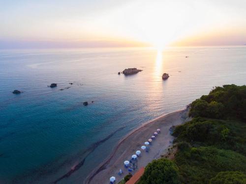an aerial view of a beach with boats in the water at Christinas lofts in Ágios Matthaíos