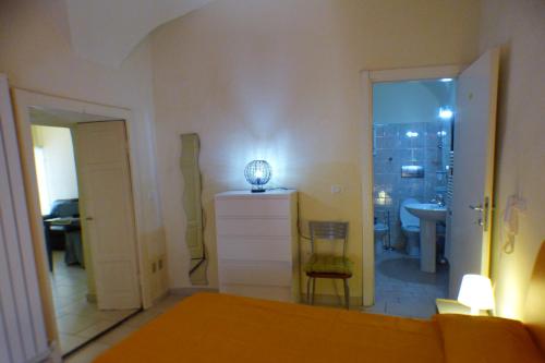 a room with a bed and a bathroom with a sink at In Centro Da Piero - Appartamento In Via Della Viola in Perugia