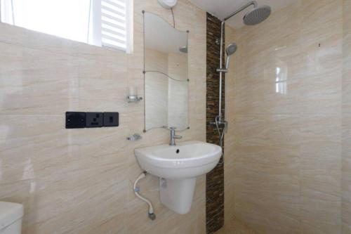 a bathroom with a sink and a mirror at Amaze Residence luxury 2 bedroom apartment 5 in Boralesgamuwa
