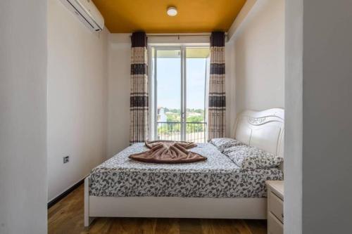 a bedroom with a bed and a window at Amaze Residence luxury 2 bedroom apartment 5 in Boralesgamuwa
