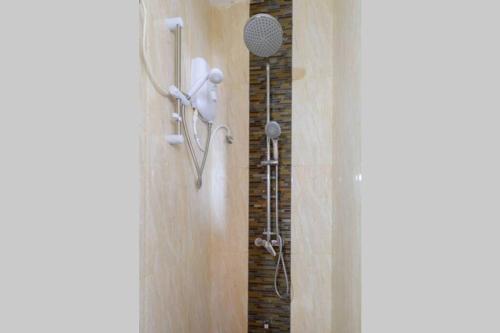 a bathroom with a shower with a shower head at Amaze Residence luxury 2 bedroom apartment 5 in Boralesgamuwa