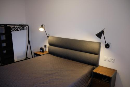 ein Schlafzimmer mit einem Bett, einer Lampe und einem Spiegel in der Unterkunft Panorama800 - Apartamenty Cameo Szklarska Poręba in Szklarska Poręba