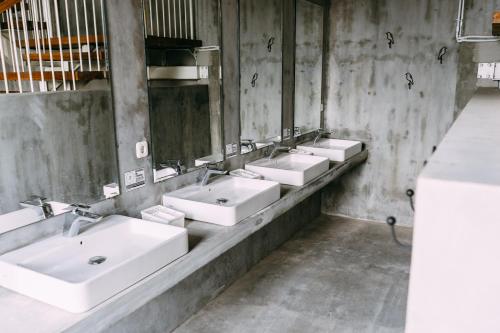 a row of sinks in a public bathroom at SO! Boutique Hostel in Malang