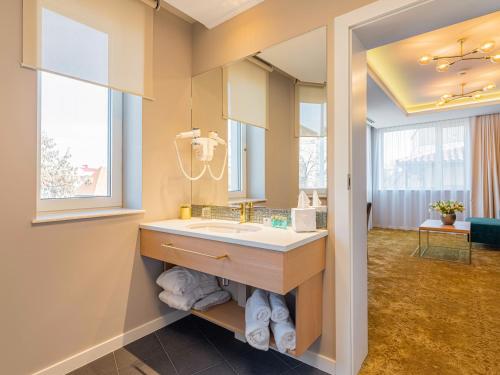 a bathroom with a sink and a mirror at Pergola Boutique Hotel in Bucharest