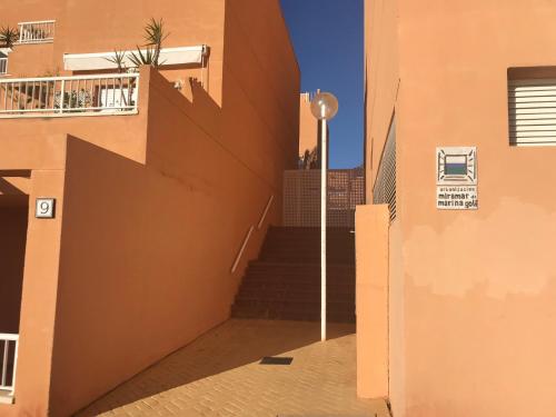a stairway with a street light next to a building at Miramar Marina de Marina Golf in Mojácar