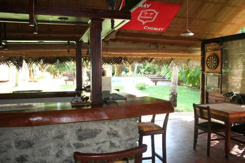 a bar in a restaurant with a table and chairs at Ging Oya Lodge in Waikkal