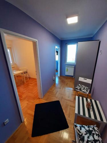 a living room with a blue wall and a table at Apartments best city place in Belgrade