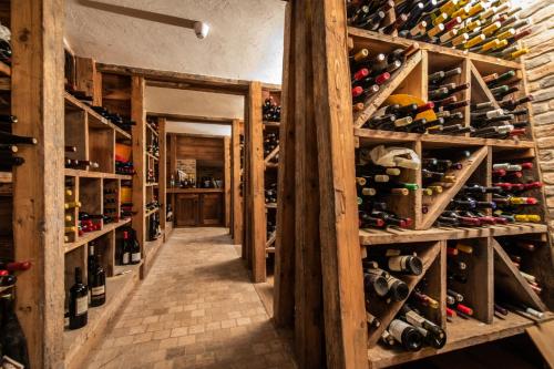 a room filled with lots of wine bottles at Monaco Sport Hotel in Santo Stefano di Cadore
