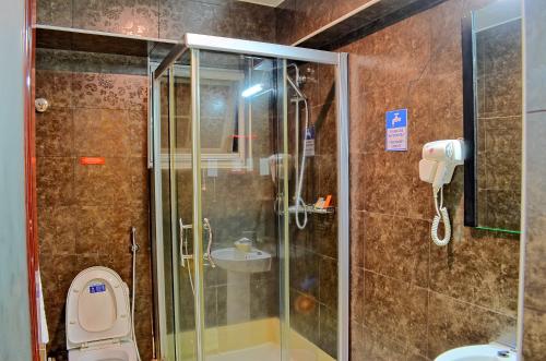 a bathroom with a shower and a toilet and a sink at Clarence House Nairobi in Nairobi