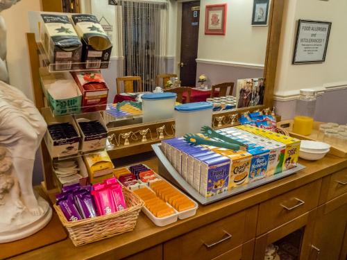 a room with a counter with many different food items at The Tudor Lodge in Skegness