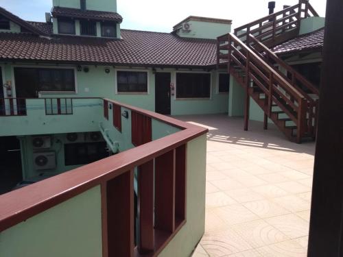 a balcony of a building with stairs and a house at Solar de Garopaba in Garopaba
