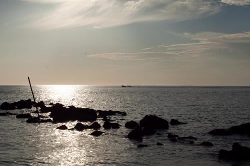 a boat is sitting on the rocks in the water at Hotel Tucan Siho Playa in Sihoplaya