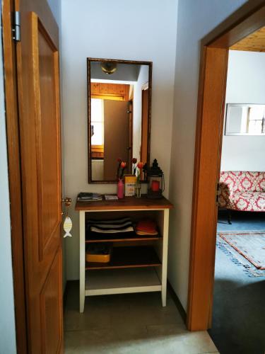 a room with a vanity with a mirror and a door at Mountain Hideaway in Garmisch-Partenkirchen
