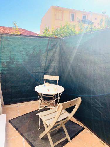a table and a chair on a patio at monaco, CHAMBRE LUXE, à 250M casino in Beausoleil