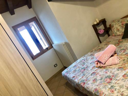 a small bedroom with a bed with a doll on it at Casa Marcela in Gravedona