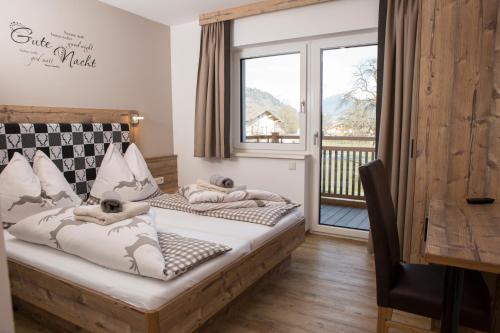 a bedroom with two beds and a balcony at Bio-Bauernhof Reiterhof in Sankt Johann im Pongau