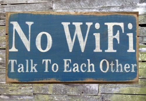a blue sign that says no wifi talk to each other at La Casa del Sole in Marina di Pisticci